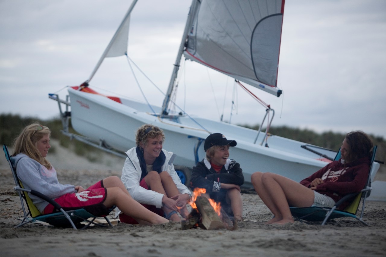 Freunde lassen den Bahia Segeltag beim Lagerfeuer am Strand ausklingen